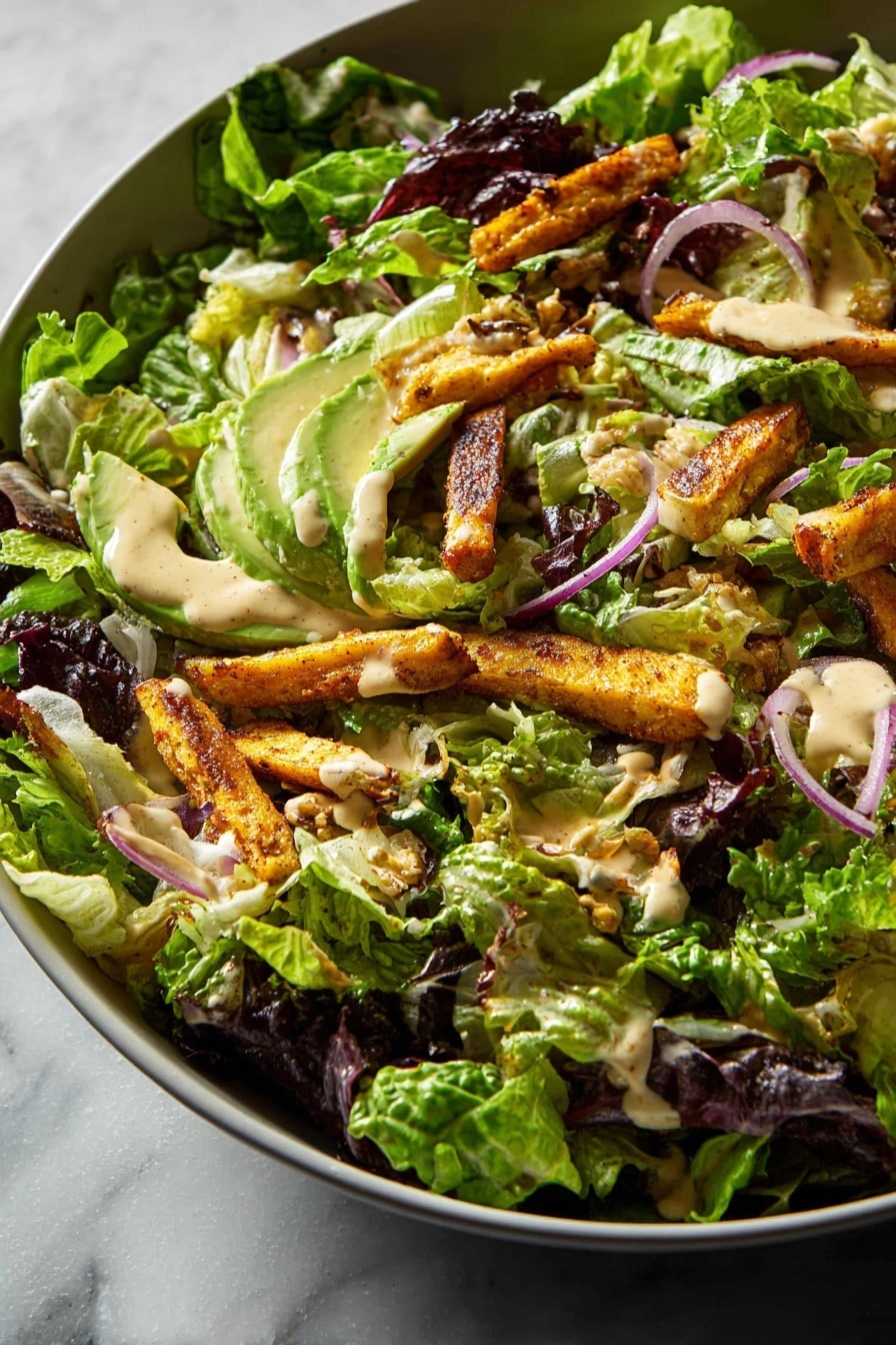 A large white bowl filled with a fresh salad showing multiple layers, starting with a base of mixed green and purple leafy lettuce with jagged and smooth edges. On top, there are several pieces of golden-brown cooked strips, likely seasoned, scattered evenly. Slices of avocado with light green smooth flesh are placed alongside thin rings of red onion adding a touch of purple. The salad is topped with a creamy beige dressing drizzled unevenly, creating soft, shiny patches over the ingredients. The background surface is a clean white marbled texture with soft lighting highlighting the freshness of the ingredients. Photo taken with an iphone --ar 2:3 --v 7 - Fig Salad with Roasted Sweet Potatoes, Chickpeas, and Tahini Dressing, healthy fig salad, roasted sweet potato salad, vegan chickpea salad, tahini dressing recipes, nutritious veggie salads