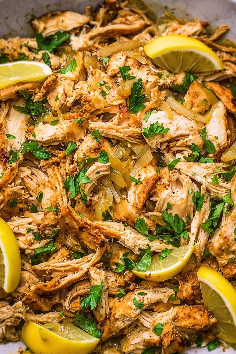 The image shows a close-up of cooked shredded chicken pieces with golden-brown seasoning spread across a white marbled surface. Mixed in are translucent cooked onion slices, adding a slight shine and texture contrast. Bright green parsley leaves are scattered evenly on top, giving fresh bursts of color. Lemon wedges with a pale yellow inside and white rinds lie partially visible within the chicken, adding visual brightness. Overall, the dish appears warm, moist, and well-seasoned with layers of light golden chicken, yellow onions, green herb flakes, and yellow lemon slices. photo taken with an iphone --ar 2:3 --v 7 - Slow Cooker Chicken Shawarma, Chicken Shawarma with Yogurt Sauce, Middle Eastern Chicken Recipes, Easy Shawarma Dinner, Tender Chicken Shawarma