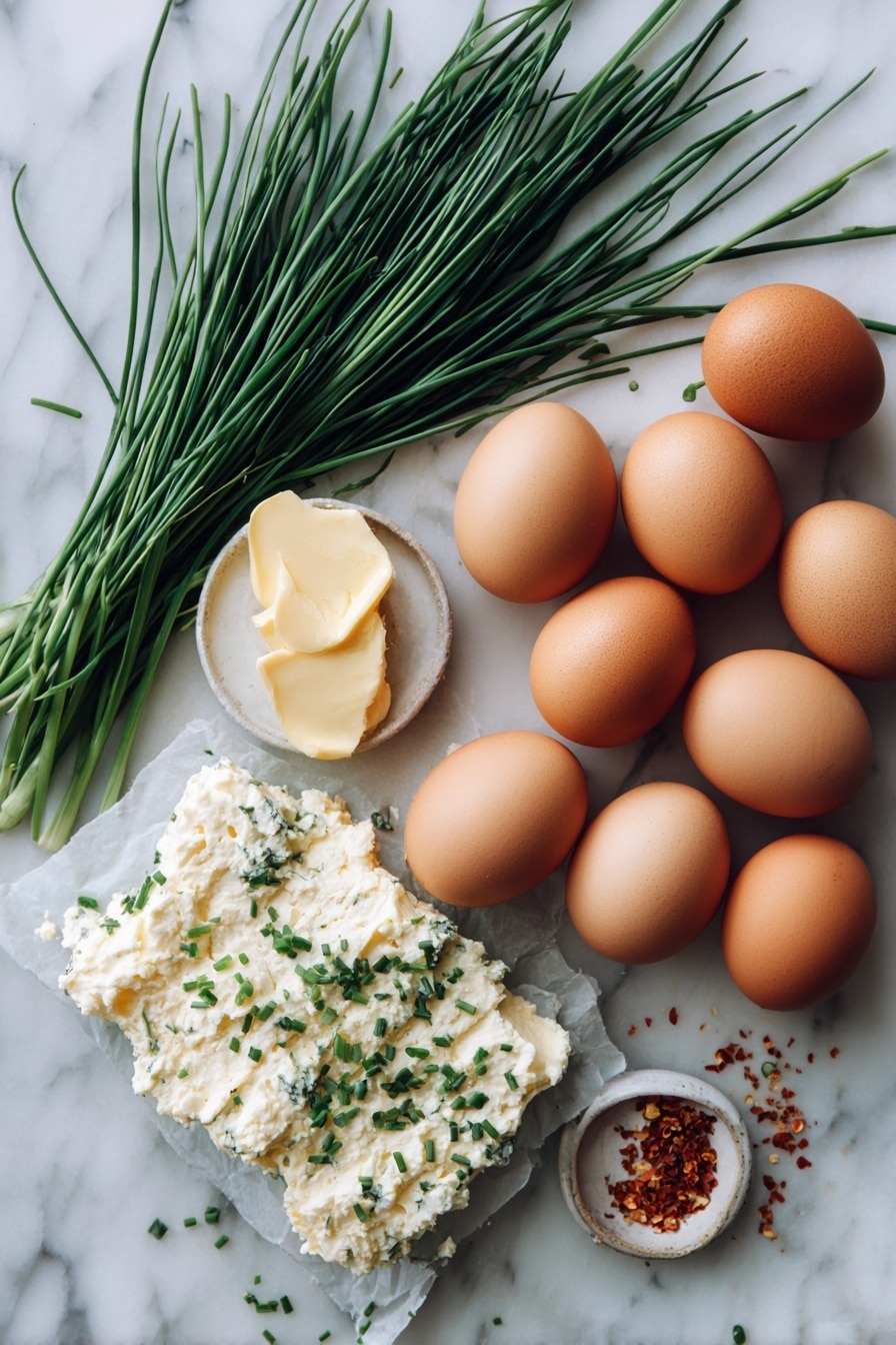 Flat lay of a block of creamy Garlic & Fine Herbs Boursin cheese, eight fresh large brown eggs, a small bunch of bright green chives, and a few scattered chili flakes, all beautifully arranged with a soft pat of golden butter, placed on a white marble surface, photo taken with an iphone --ar 2:3 --v 7 - Garlic Herb Boursin Scrambled Egg Bake, creamy breakfast casserole, easy breakfast baked eggs, flavorful brunch egg dish, quick egg bake with herbs