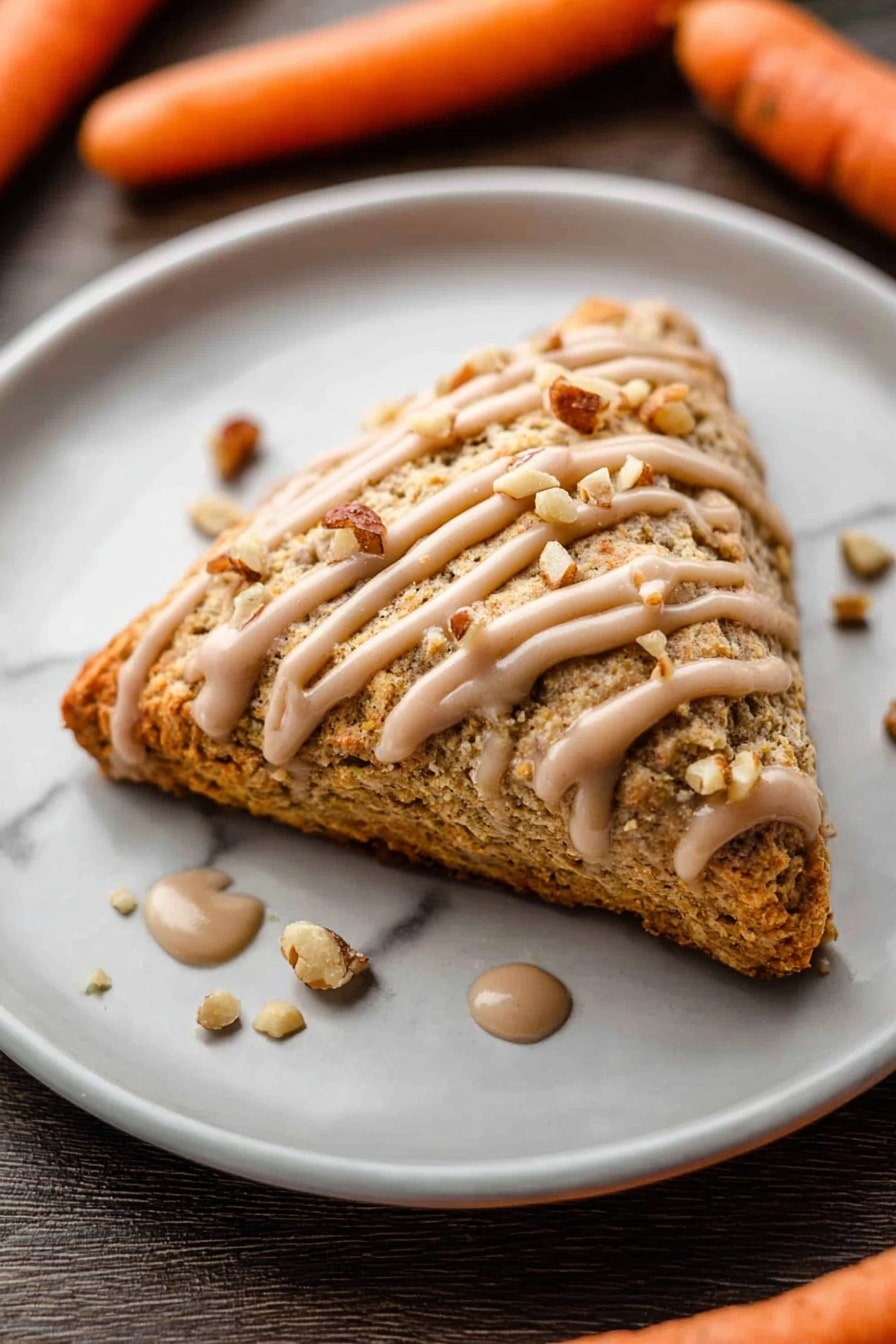 A square piece of carrot cake with a rough texture and orange bits inside sits in the middle of a white plate with a white marbled background. The cake is topped with a thick, light brown sauce drizzled across the top and sprinkled crushed nuts over it. A gold fork on the right side holds a small piece of cake covered in the same sauce, with a woman's hand holding the fork. Around the plate, there are small scattered crumbs and crushed nuts, with two whole carrots placed diagonally on the white marbled surface. Photo taken with an iphone --ar 2:3 --v 7 - Carrot Cake Scones with Cinnamon Glaze, carrot cake scones, cinnamon glaze scones, easy carrot scones, brunch scones recipes