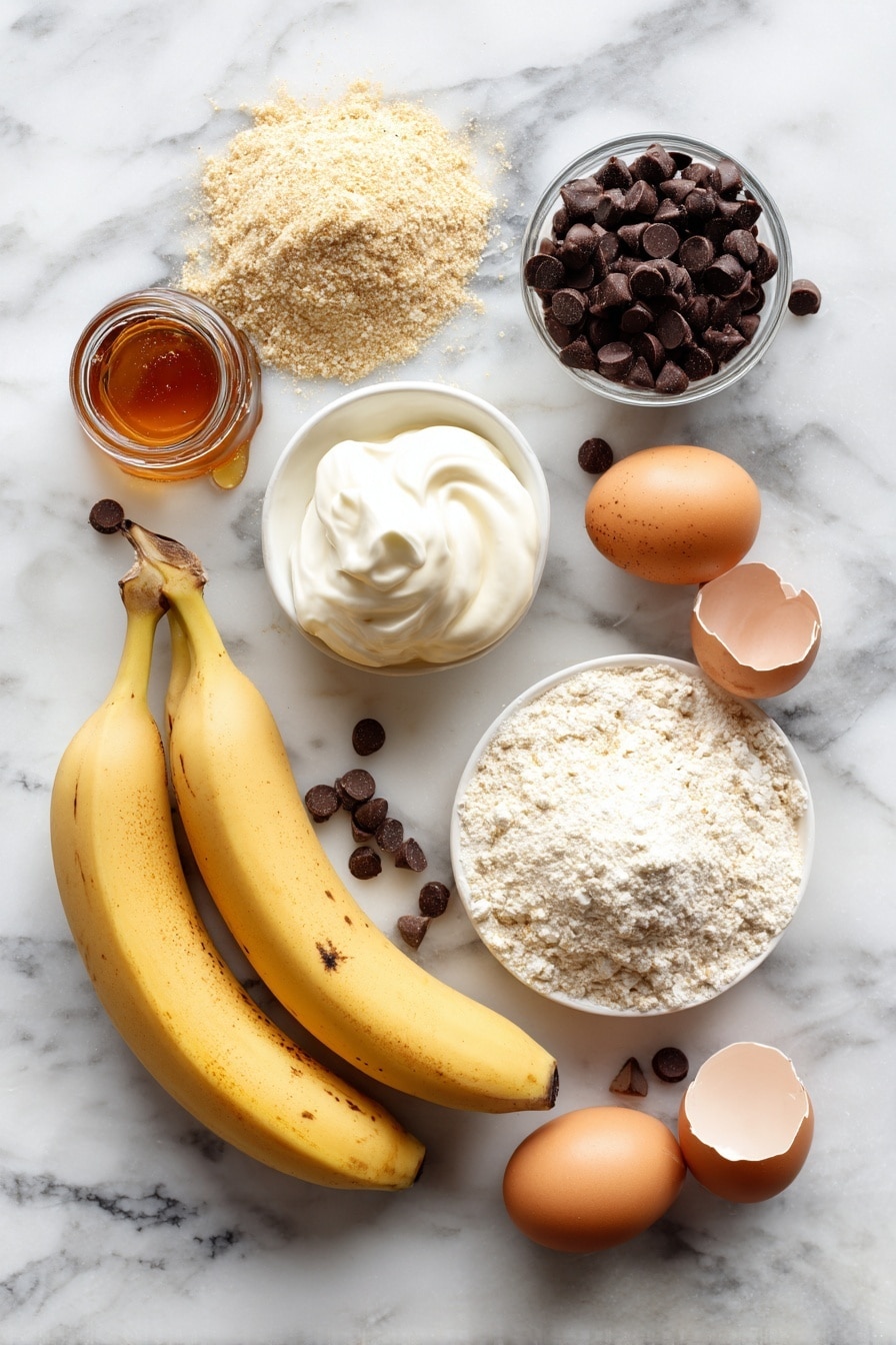 Flat lay of ripe mashed bananas, whole eggs, creamy full-fat Greek yogurt, smooth almond flour, fine oat flour, scoop of protein powder, rich amber maple syrup, shiny dark chocolate chips, and a small bottle of pure vanilla extract beautifully arranged on a white marble surface, photo taken with an iphone --ar 2:3 --v 7 - Protein Banana Bread with Chocolate Chips, healthy banana bread, protein banana bread recipe, nutritious banana bread, easy banana bread with chocolate chips