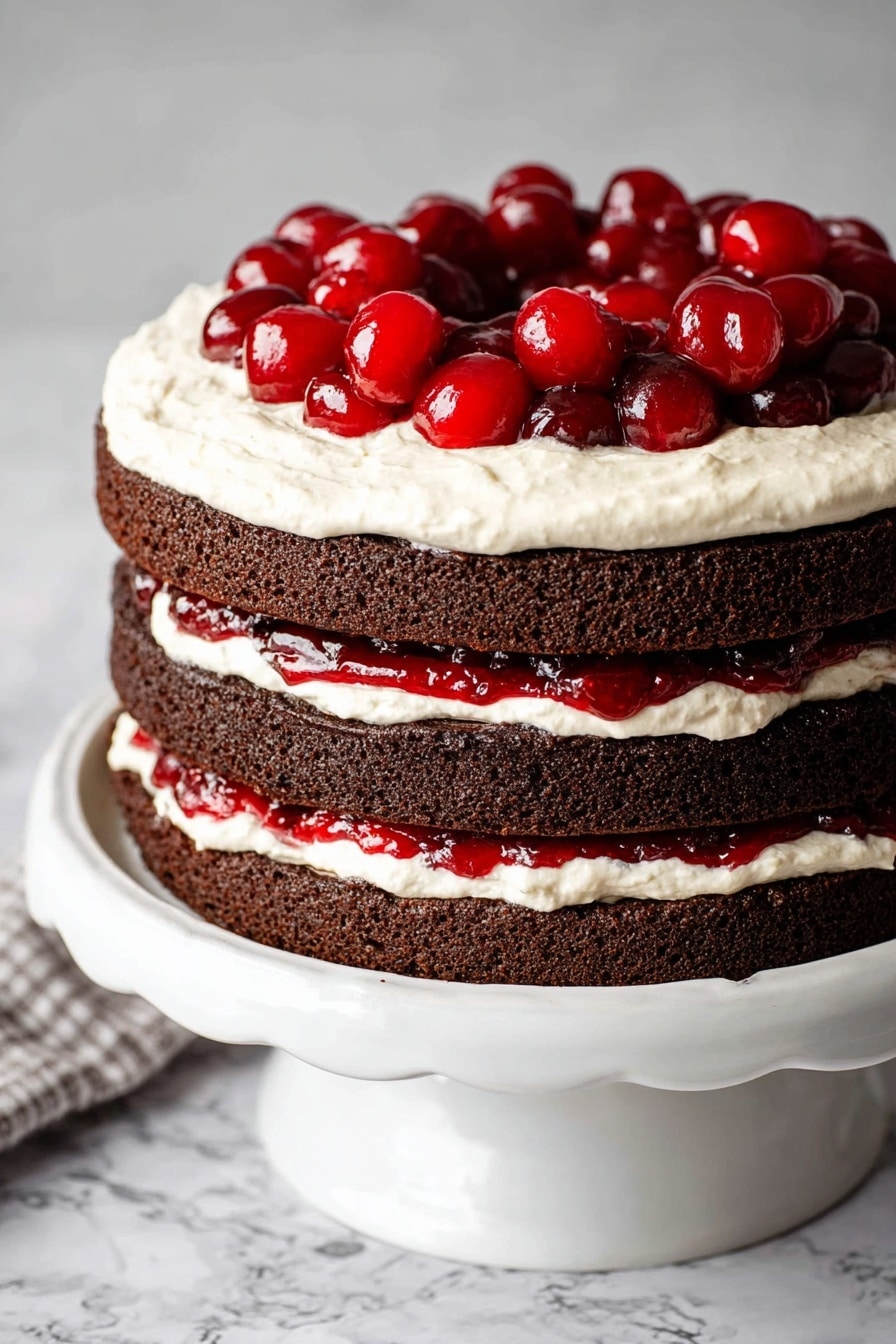 The image shows a three-layer chocolate cake with white cream and bright red cherry filling between each layer. The cake is cut, showing the thick, soft chocolate layers separated by smooth white cream and shiny cherry sauce with whole cherries. The cake is on a white cake stand with a scalloped edge, sitting on a white marbled surface with a gray and white striped cloth around it. A slice of the cake is placed on a white plate in front with a silver fork resting next to it, showing the moist texture, cream, and cherries clearly. Photo taken with an iphone --ar 2:3 --v 7 - Aunt Becky’s Black Forest Cherry Cake, Black Forest Cherry Cake, Cherry Chocolate Cake, Old-Fashioned Cherry Cake, Classic Black Forest Dessert