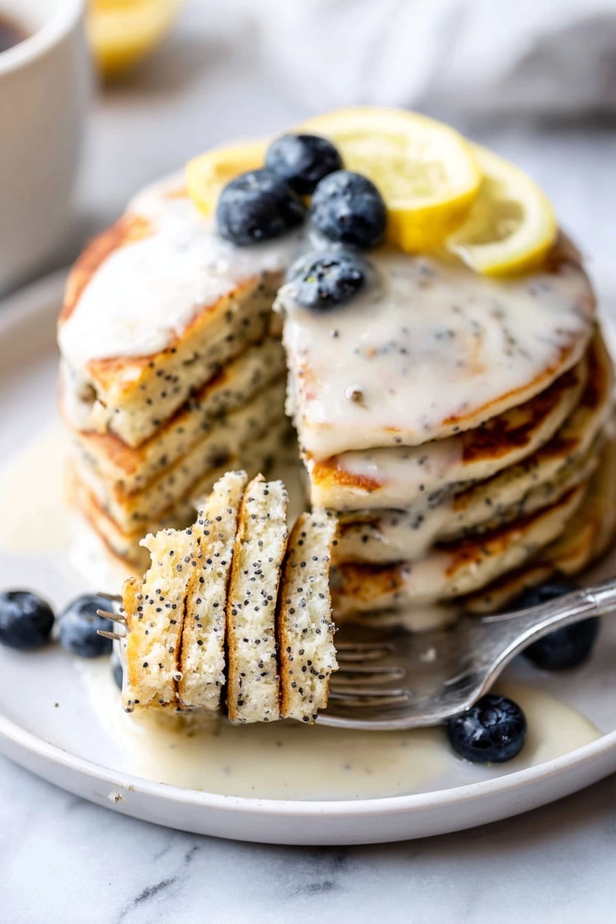 A stack of six thick, light-colored pancakes with black poppy seeds throughout stands on a white plate with a white marbled surface underneath. The top pancake is covered in a light cream sauce that drips down the sides. On top are several dark blue blueberries and a thin lemon slice with a bright yellow rind and pale inside. A silver fork lifts a bite-sized piece of pancakes from the front of the stack, showing a soft, fluffy texture with some cream sauce on it. More blueberries rest on the plate near the stack. photo taken with an iphone --ar 2:3 --v 7 - Lemon Poppy Seed Pancakes with Lemon Glaze, lemon pancake recipe, easy lemon pancakes, fluffy lemon pancakes with glaze, morning breakfast lemon pancakes