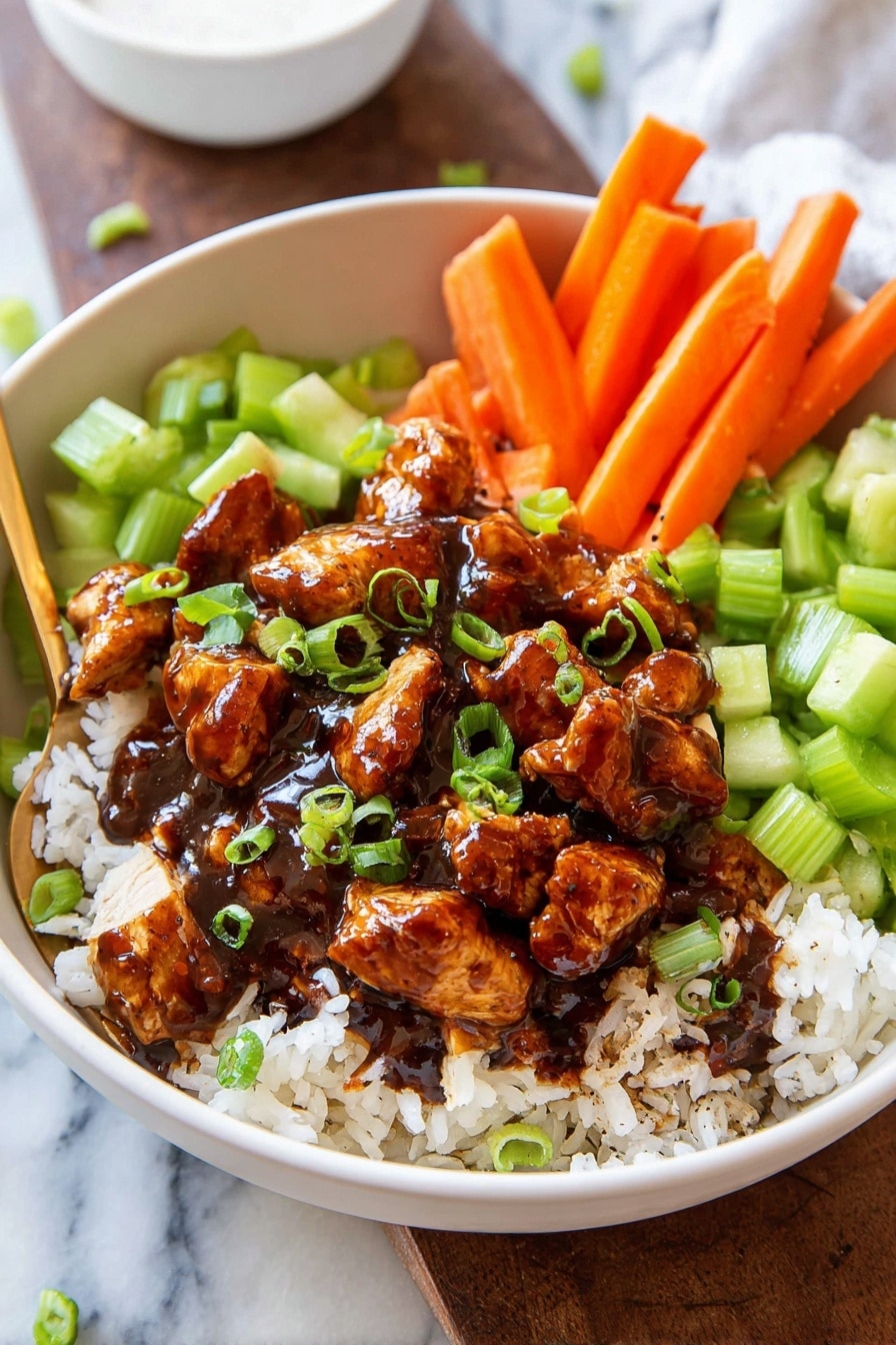 The image shows a white bowl filled with a layered dish. The bottom layer is soft white rice scattered unevenly inside the bowl. On top of the rice are pieces of cooked chicken coated in a thick, glossy dark brown sauce, forming the central layer. Surrounding the chicken are brightly colored vegetable layers – on one side, fresh light green chopped celery pieces with a bit of dark seasoning, and on the other side, bright orange carrot sticks arranged upright. The dish is sprinkled with chopped fresh green onions for a touch of color and texture. A gold fork rests inside the bowl, leaning against the right side. The bowl sits on a white marbled surface with a blurred white sauce bowl in the background. Photo taken with an iphone --ar 2:3 --v 7 - Crispy Buffalo Chicken Bowls, buffalo chicken bowls healthy, spicy chicken bowls recipe, easy buffalo chicken dinner, homemade buffalo chicken bowls