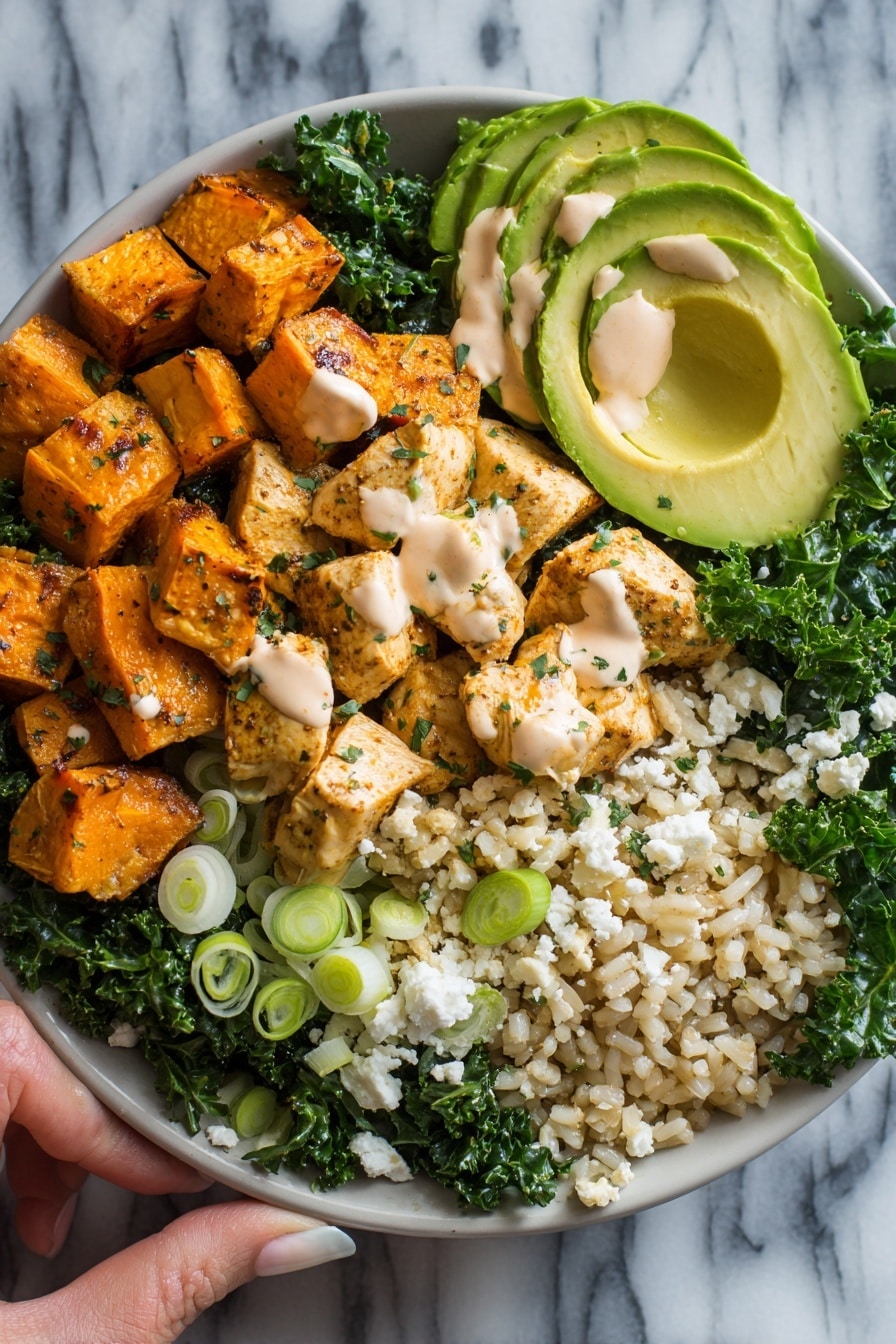 Flat lay of roasted sweet potato cubes with a golden, slightly charred surface, tender bite-sized pieces of cooked chicken breast seasoned with spices, bright green massaged kale leaves glistening with olive oil and lemon juice, fluffy cooked brown rice grains, creamy white dollops of chipotle yogurt sauce with a hint of orange, sliced fresh avocado with smooth, light green flesh, crumbled white feta cheese bits, and scattered thin slices of vibrant green onions, all placed on a white marble surface, photo taken with an iphone --ar 2:3 --v 7 - Roasted Sweet Potato, Chicken, Kale, and Rice Bowls for Two, healthy meal bowls for two, easy nutritious dinner, simple roasted chicken bowl, colorful veggie rice bowl