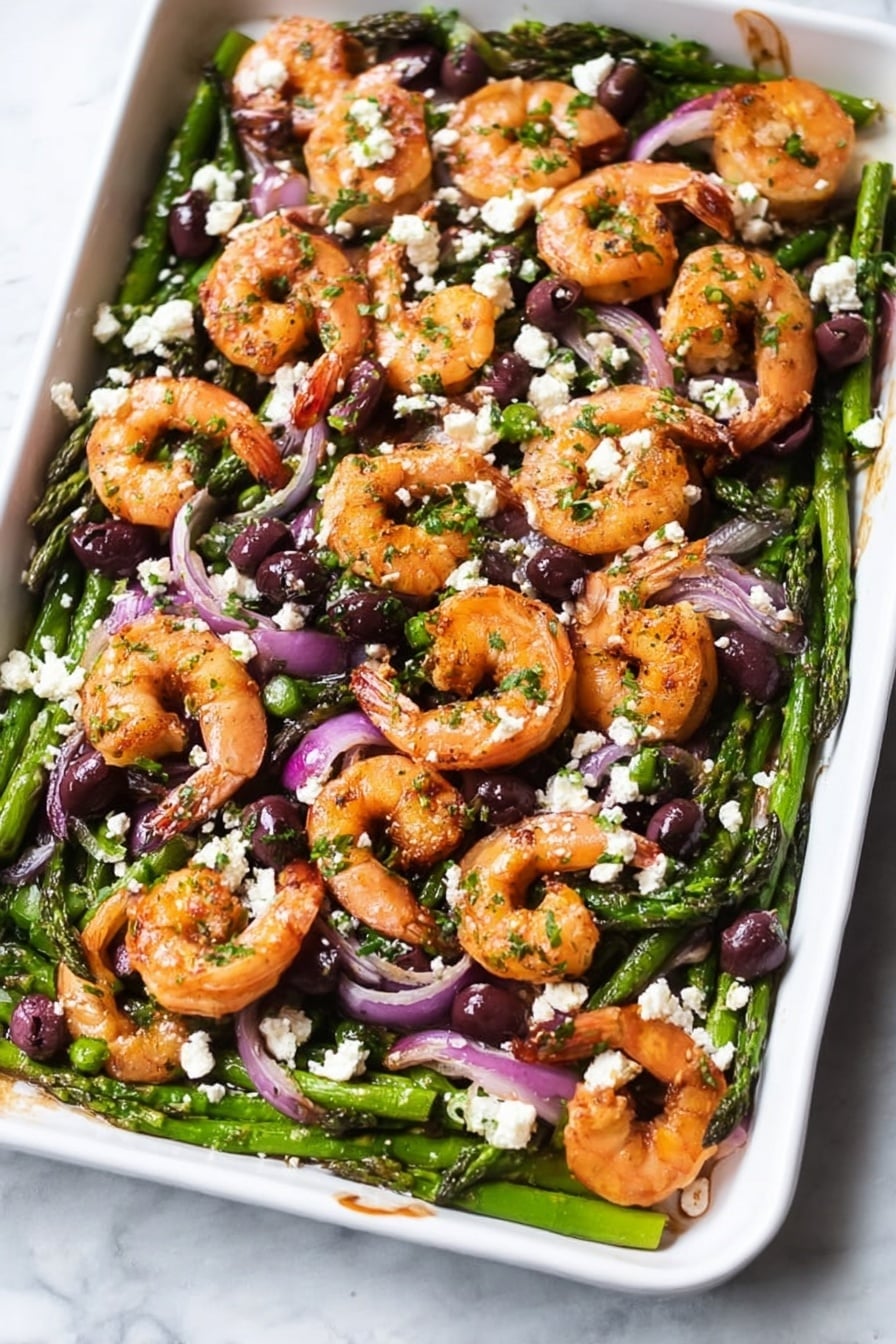 A white tray filled with a colorful mix of cooked shrimp, green asparagus, red onion slices, black olives, and crumbled white cheese, all sprinkled with chopped green herbs. The shrimp are orange with grill marks and rest on a layer of bright green asparagus spears. The red onion adds purple and white tones, scattered evenly throughout. Black olives are dotted on top, along with small clumps of white cheese, giving a mix of colors and textures. The white marbled surface underneath adds a clean, bright background. photo taken with an iphone --ar 2:3 --v 7 - Sheet Pan Mediterranean Shrimp, Mediterranean Shrimp Dish, Easy Shrimp Dinner, Healthy Seafood Recipes, One-Pan Shrimp Meal